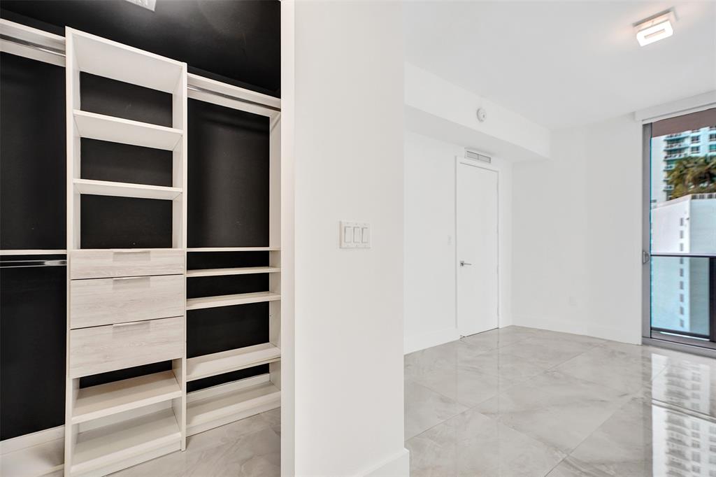 488 Northeast 18th Street, Unit 801 Miami, FL 33132 - Photo 7 of 46 a view of walk in closet with empty racks