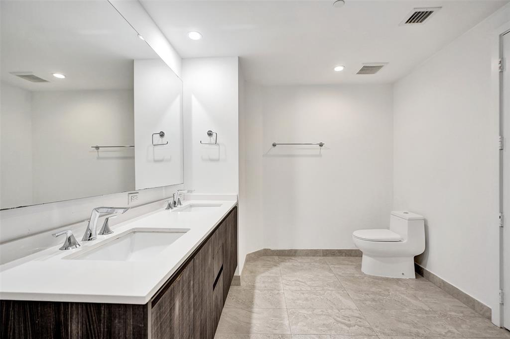 488 Northeast 18th Street, Unit 801 Miami, FL 33132 - Photo 9 of 46 a bathroom with a sink toilet and a mirror