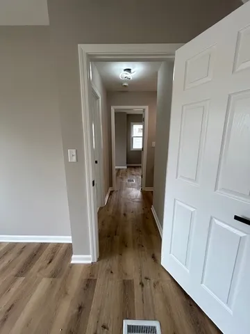 wooden floor in a hall with an entryway