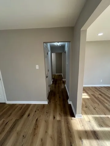 a view of a hallway with wooden floor