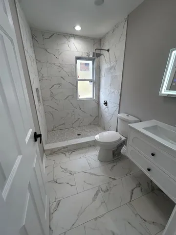 a bathroom with a sink toilet and shower