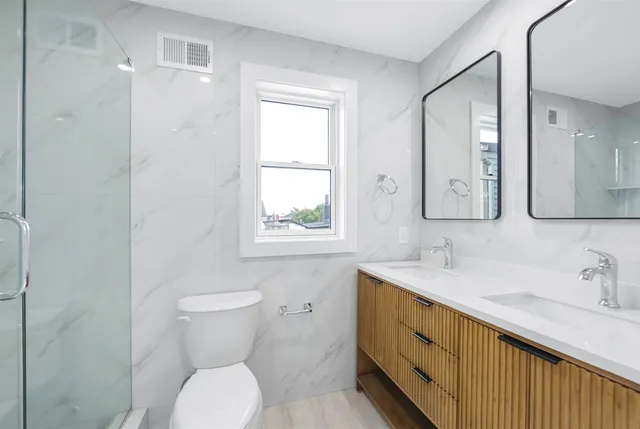 a bathroom with a toilet sink and mirror