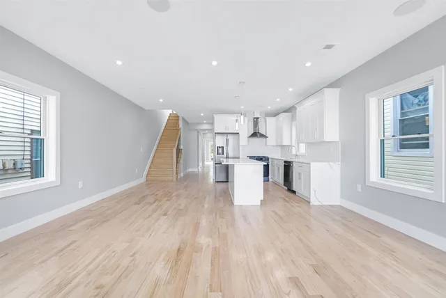 a view of kitchen with wooden floor and electronic appliances