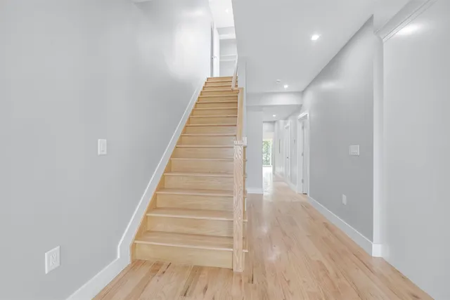 a view of entryway and hall with wooden floor