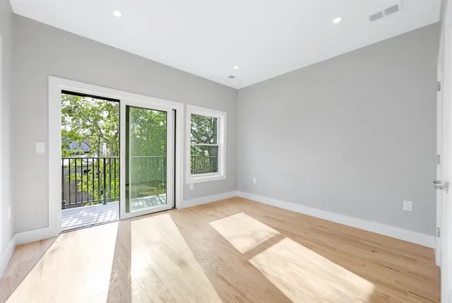 a view of wooden floor and windows in a room