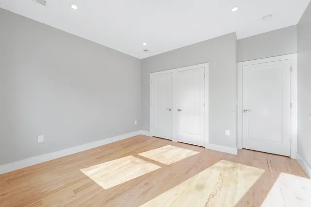 a view of a room with wooden floor