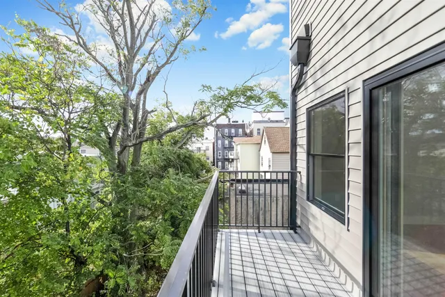 a view of balcony with wooden floor and fence