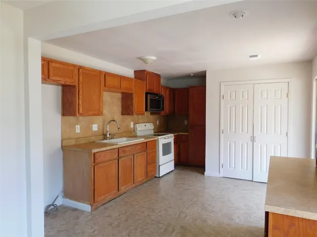 a kitchen with stainless steel appliances granite countertop a sink and cabinets