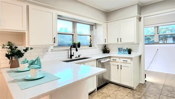 a kitchen with sink refrigerator and window