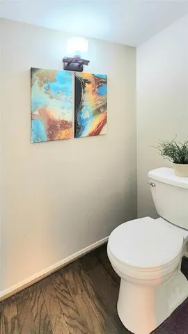 a white toilet sitting next to a bathroom sink