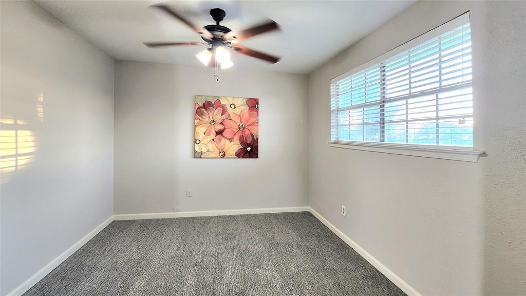 1911 Greenhaven Drive Richardson, TX 75080 - Photo 24 of 38 an empty room with a window and a fan
