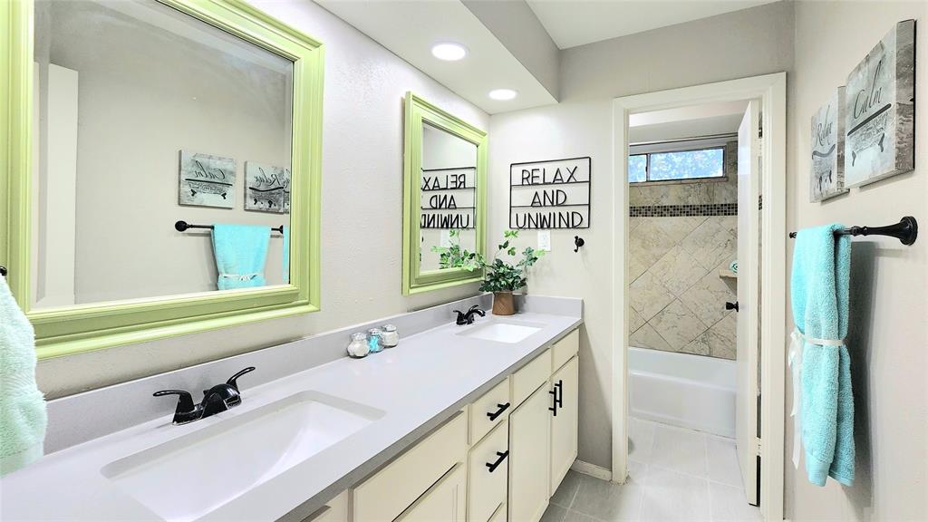 1911 Greenhaven Drive Richardson, TX 75080 - Photo 26 of 38 a bathroom with a tub sink and mirror