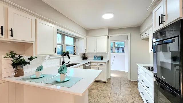 a kitchen with sink refrigerator and stove