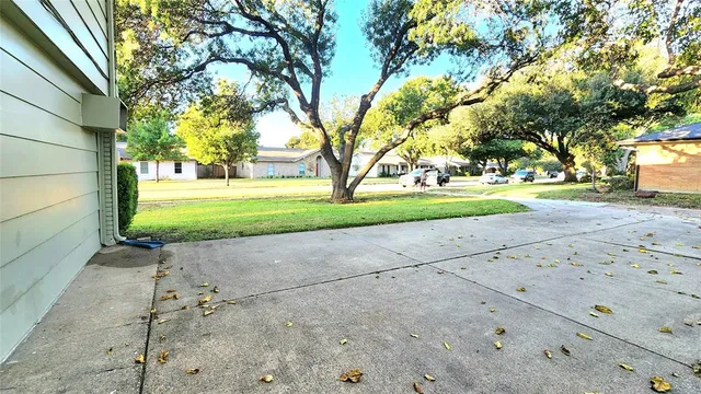 a view of a yard with yellow house