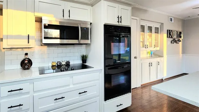a kitchen with stainless steel appliances a stove a microwave and cabinets