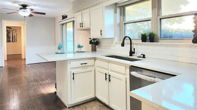 a kitchen with stainless steel appliances cabinets a sink and a window