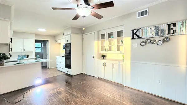 a view of a kitchen with a refrigerator cabinets and wooden floor