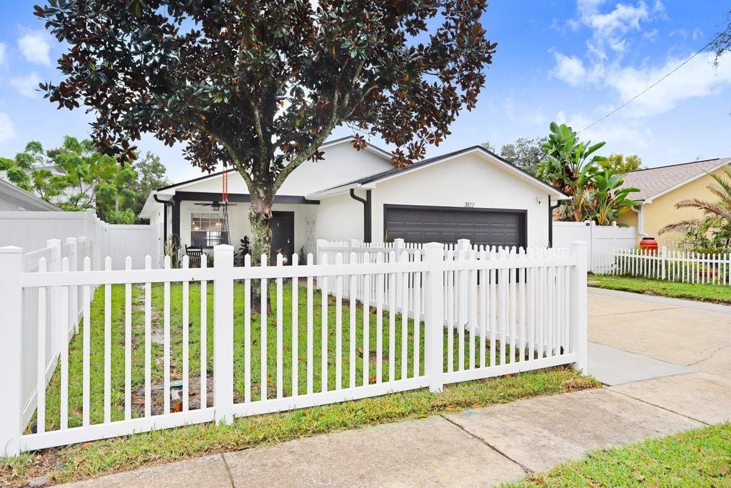 3122 West Grace Street Tampa, FL 33607 - Photo 1 of 31 a front view of a house with a garden