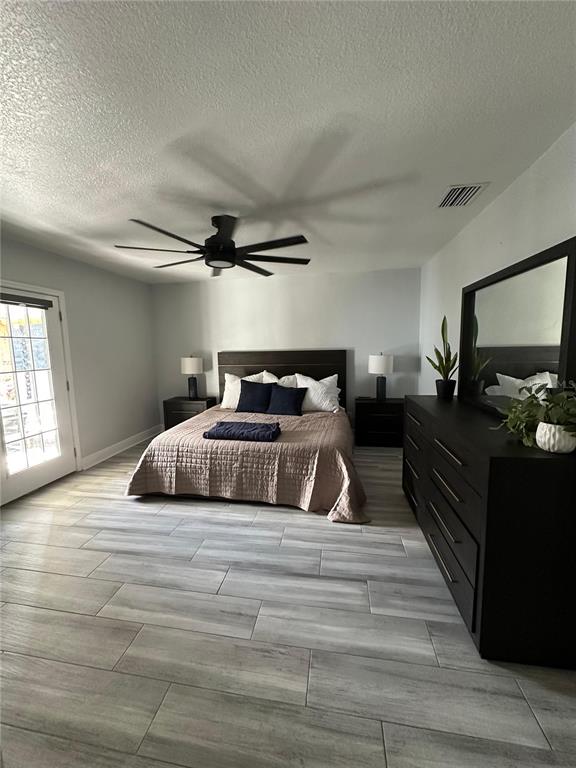 3122 West Grace Street Tampa, FL 33607 - Photo 20 of 46 a bedroom with a bed and wooden floor