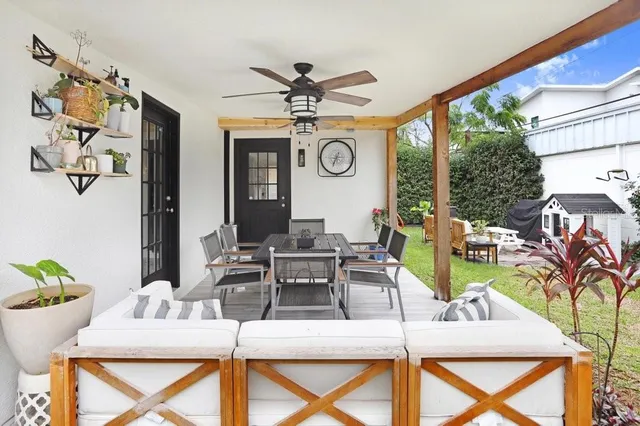 a living room with patio furniture and a large window