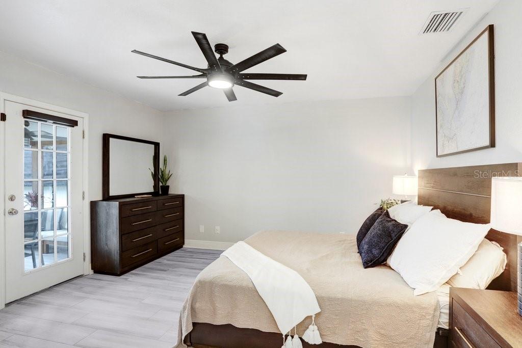 3122 West Grace Street Tampa, FL 33607 - Photo 28 of 46 a bedroom with a bed and wooden floor