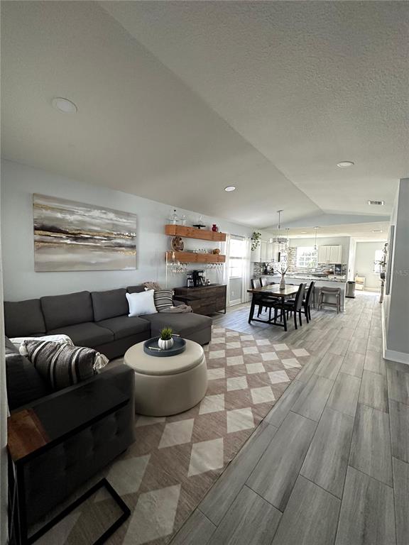 3122 West Grace Street Tampa, FL 33607 - Photo 4 of 46 a living room with furniture a wooden floor and a rug