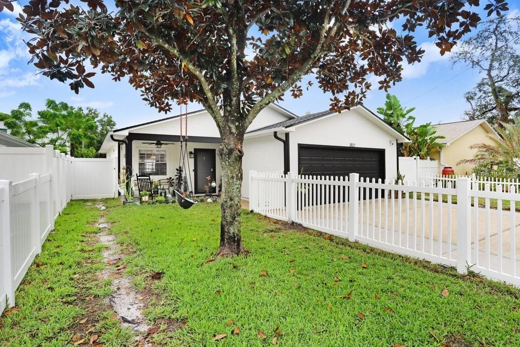 3122 West Grace Street Tampa, FL 33607 - Photo 44 of 46 a front view of a house with a yard table and chairs