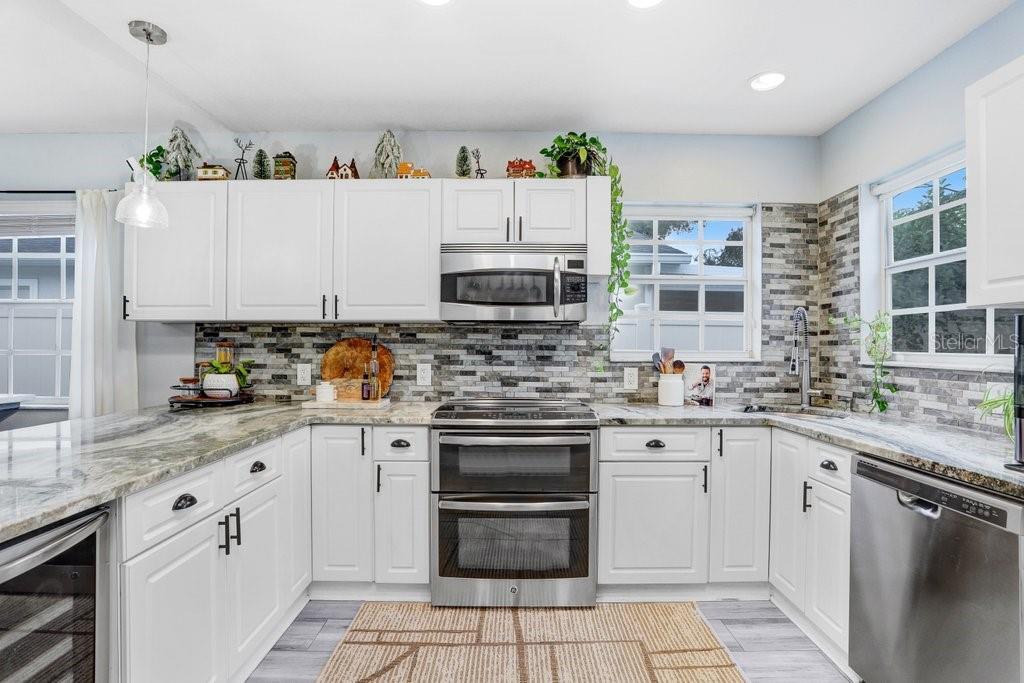 3122 West Grace Street Tampa, FL 33607 - Photo 10 of 31 a kitchen with stainless steel appliances granite countertop a sink and cabinets