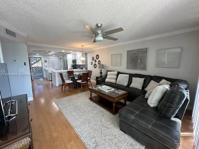 a living room with furniture and a chandelier