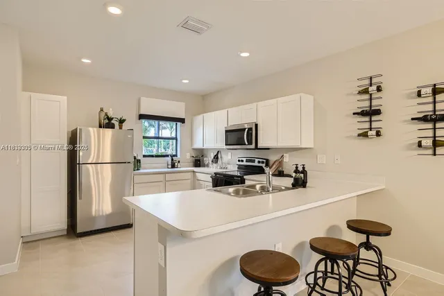 a kitchen with stainless steel appliances a refrigerator stove and microwave