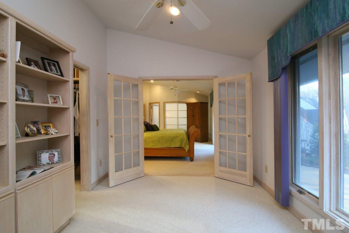 7209 Rainwater Road Raleigh, NC 27615 - Photo 14 of 25 a bedroom with a bed and a walk in closet