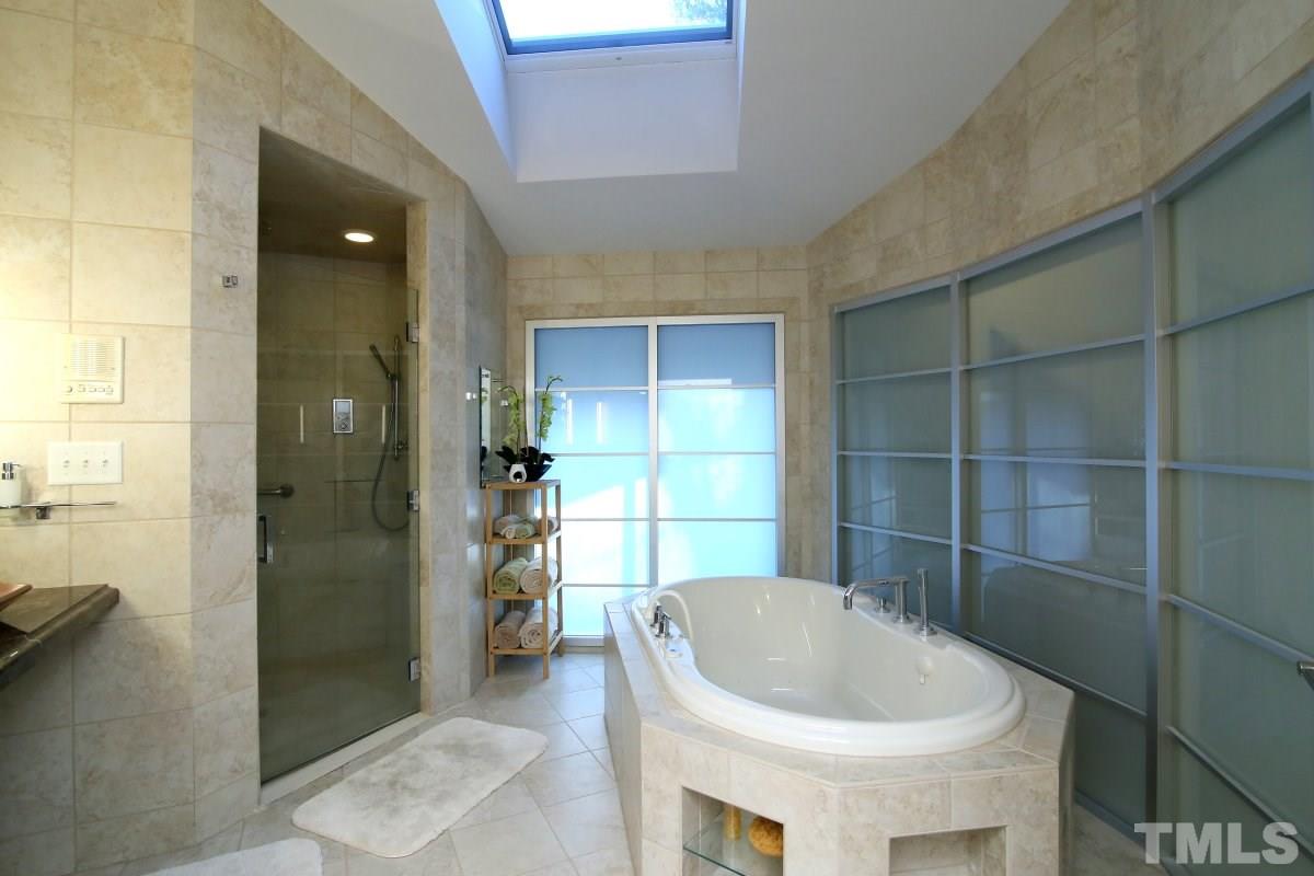 7209 Rainwater Road Raleigh, NC 27615 - Photo 16 of 25 a bathroom with a bathtub and a shower