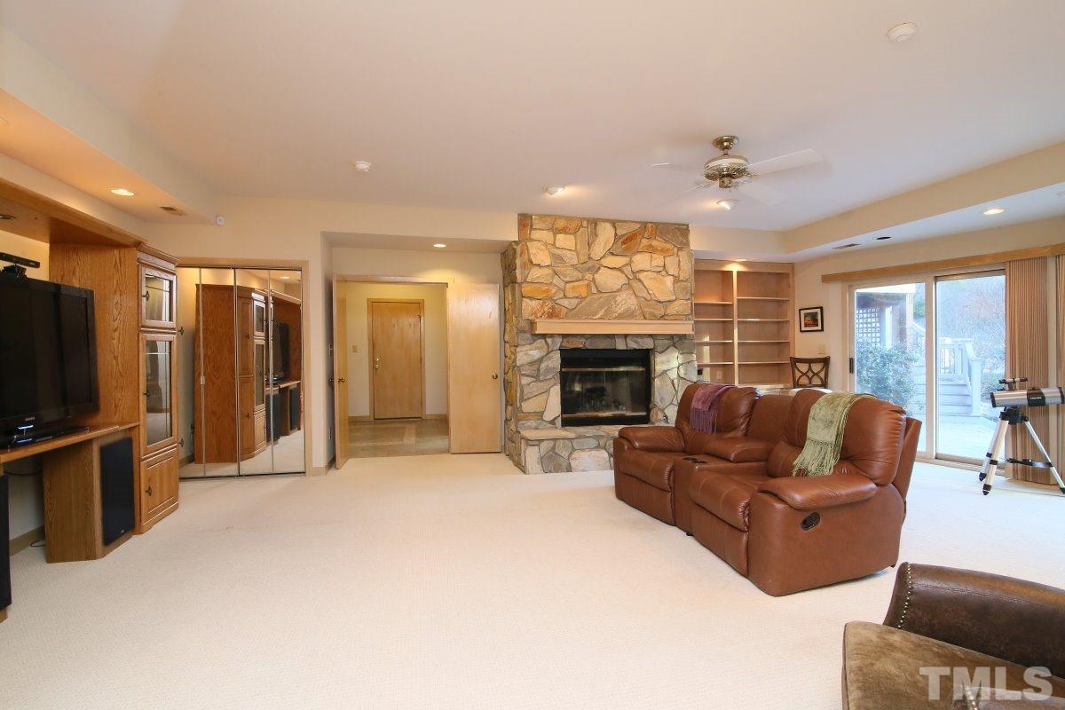 7209 Rainwater Road Raleigh, NC 27615 - Photo 18 of 25 a living room with furniture flat screen tv and a fireplace