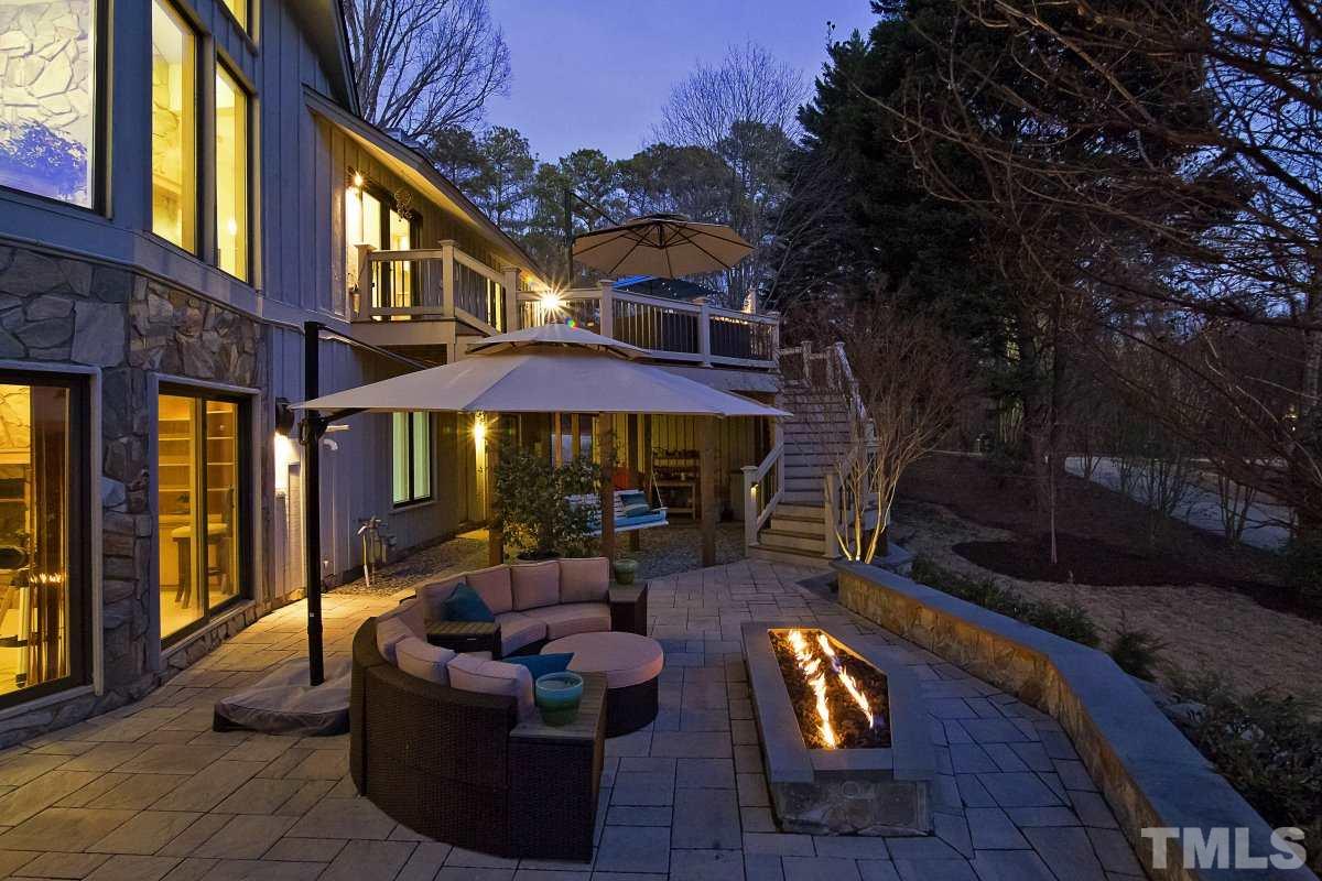 7209 Rainwater Road Raleigh, NC 27615 - Photo 23 of 25 a view of a patio with couches table and chairs and potted plants