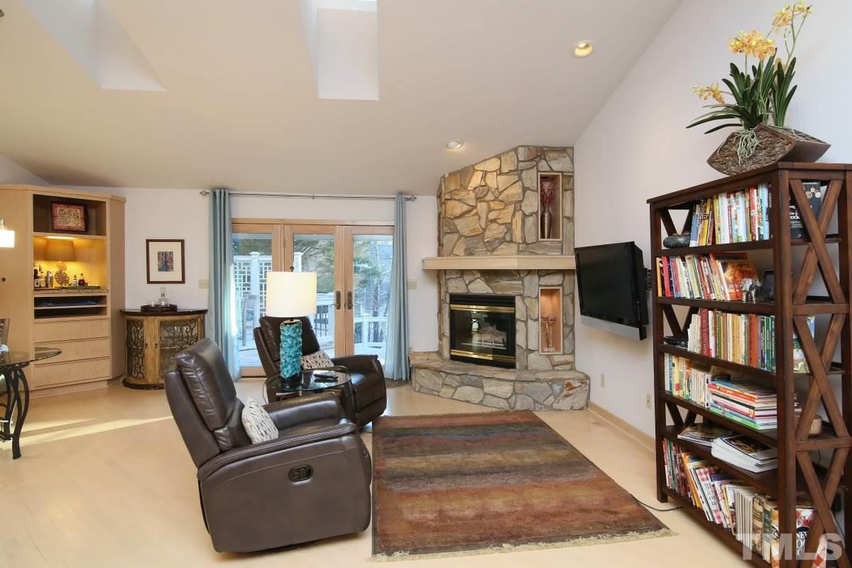 7209 Rainwater Road Raleigh, NC 27615 - Photo 10 of 25 a living room with furniture fireplace and book shelf