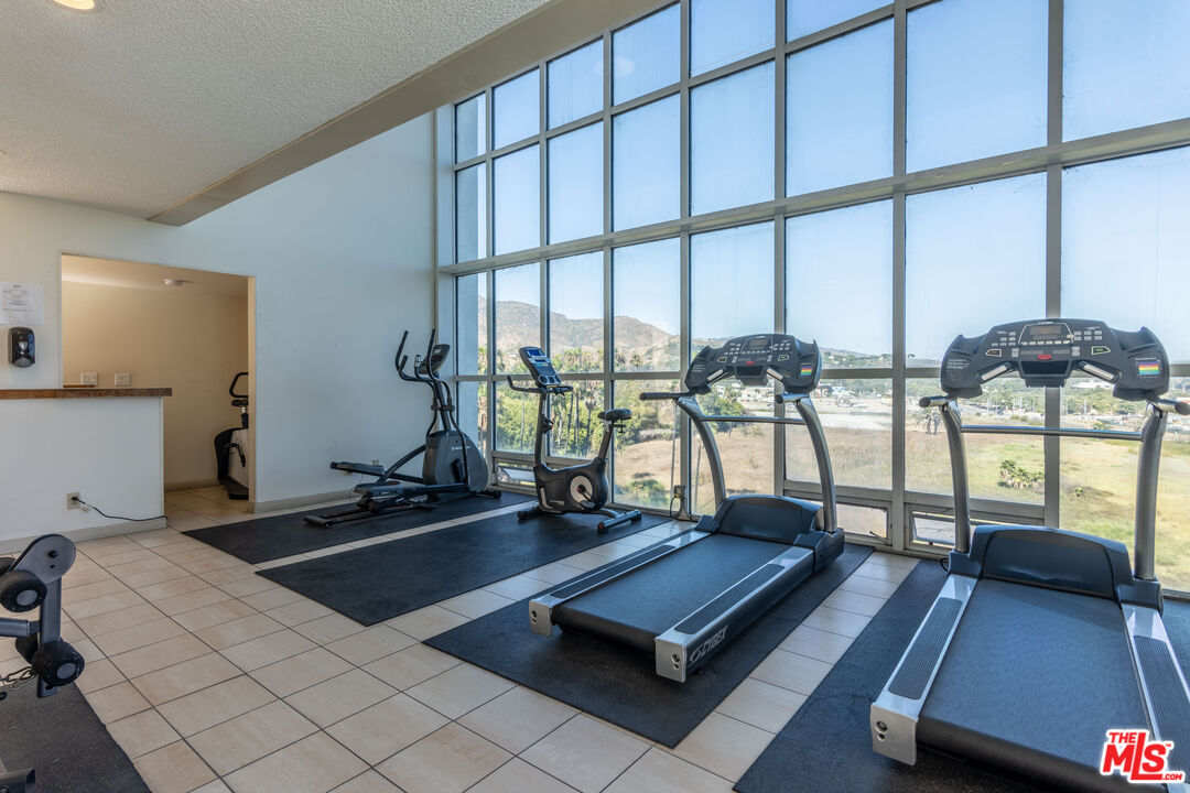23901 Civic Center Way, Unit B137 Malibu, CA 90265 - Photo 15 of 27 a room with gym equipment and a large window