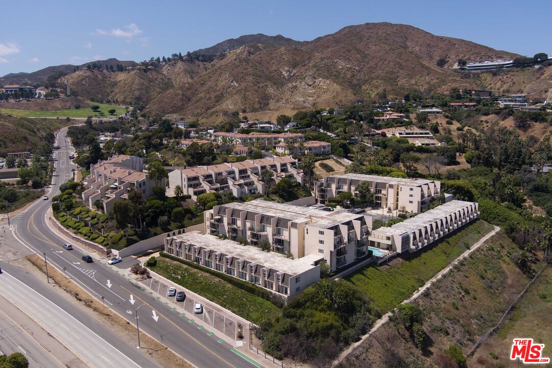 23901 Civic Center Way, Unit B137 Malibu, CA 90265 - Photo 20 of 27 a view of a house with a garden and mountains