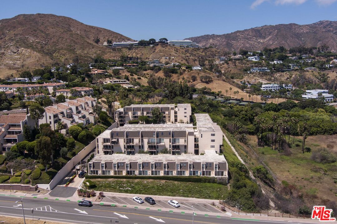 23901 Civic Center Way, Unit B137 Malibu, CA 90265 - Photo 21 of 27 a view of a big house with a mountain in the background