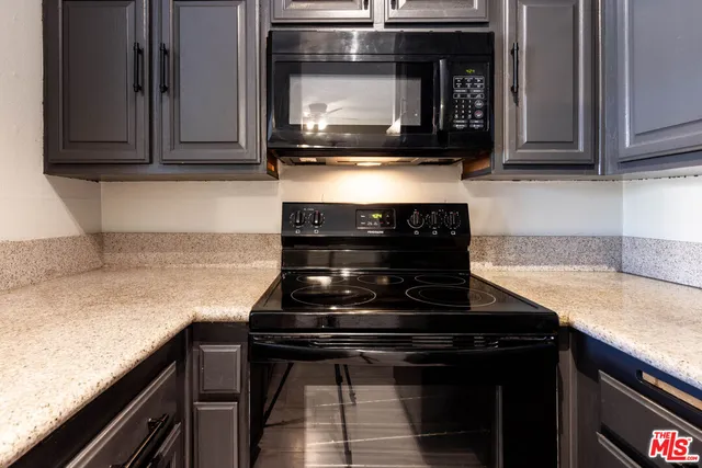 a kitchen with a stove and a microwave