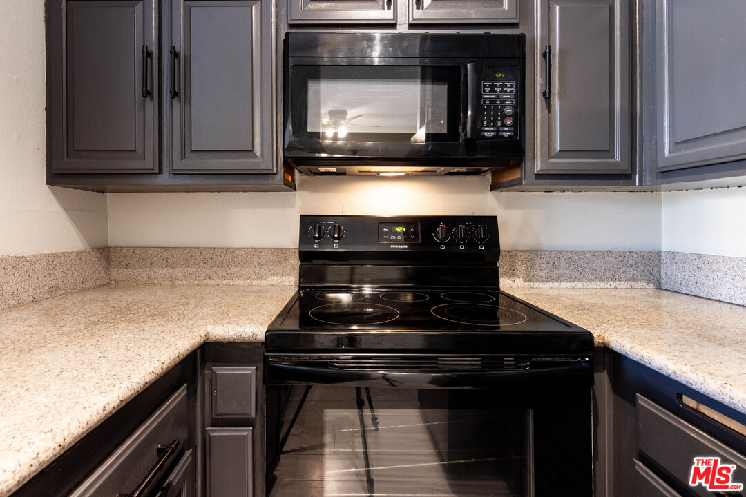 23901 Civic Center Way, Unit B137 Malibu, CA 90265 - Photo 6 of 27 a kitchen with a stove and a microwave