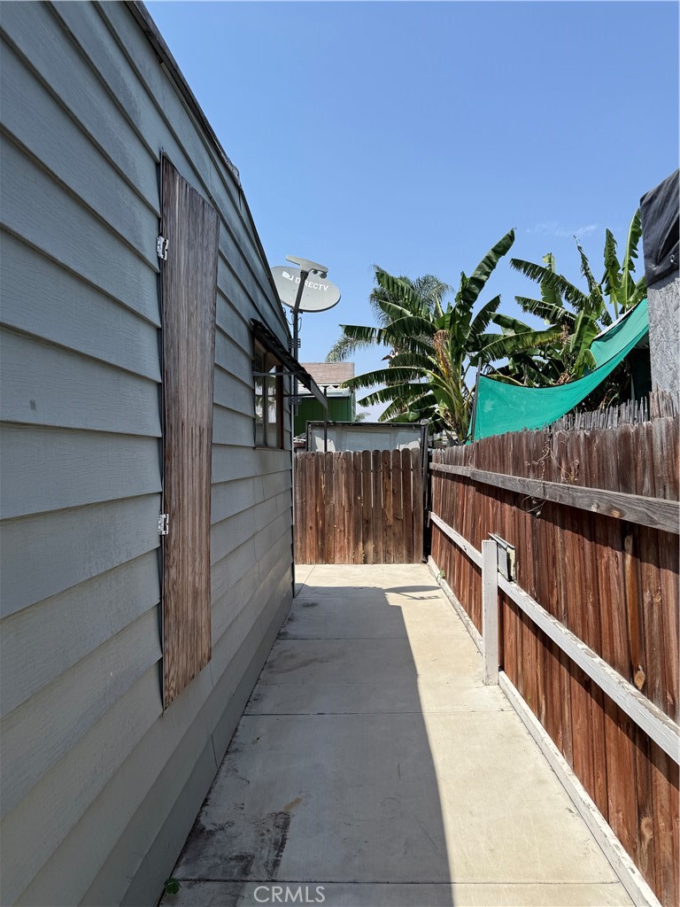 16600 Orange Avenue, Unit 63 Paramount, CA 90723 - Photo 11 of 12 a view of balcony with wooden floor and potted plants
