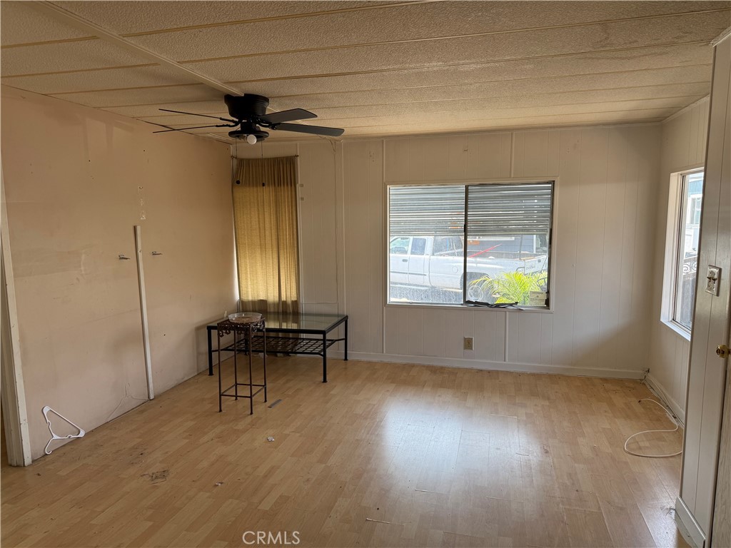 16600 Orange Avenue, Unit 63 Paramount, CA 90723 - Photo 4 of 12 an empty room with windows and ceiling fan