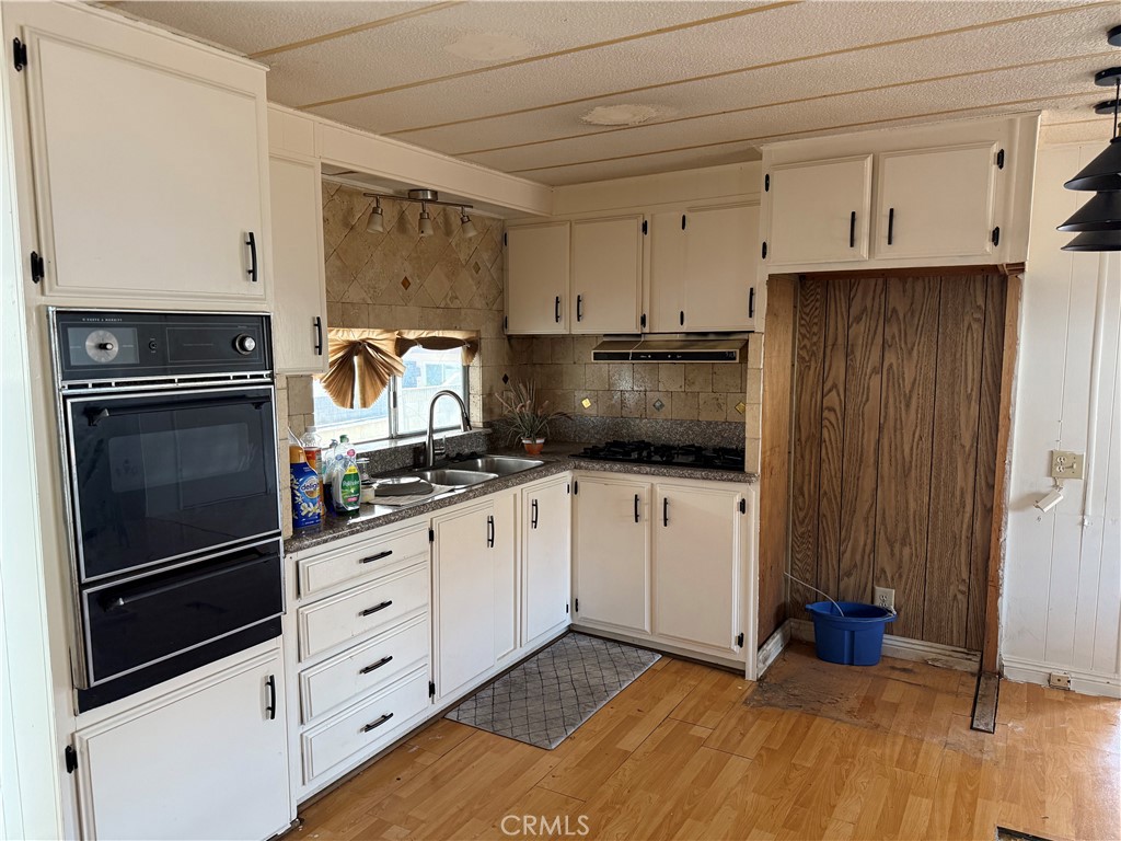 16600 Orange Avenue, Unit 63 Paramount, CA 90723 - Photo 5 of 12 a kitchen with granite countertop cabinets and steel stainless steel appliances