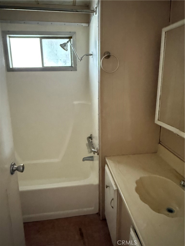 16600 Orange Avenue, Unit 63 Paramount, CA 90723 - Photo 8 of 12 a bathroom with a tub and a sink