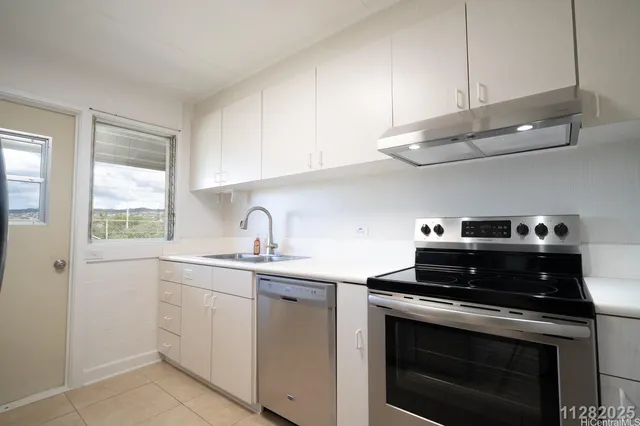 a kitchen with a refrigerator and a sink