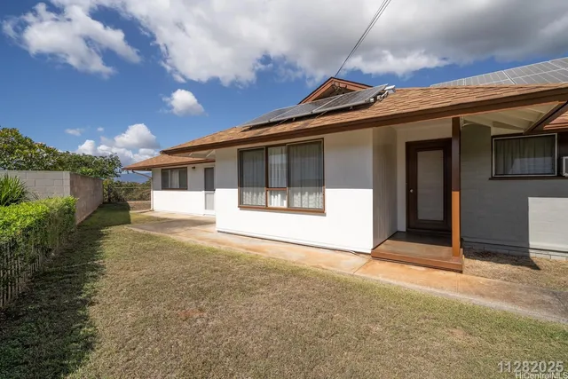 a view of a house with backyard and balcony