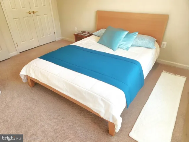 a bedroom with a bed and pillows