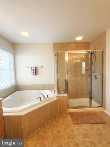 a bathroom with a bathtub and shower