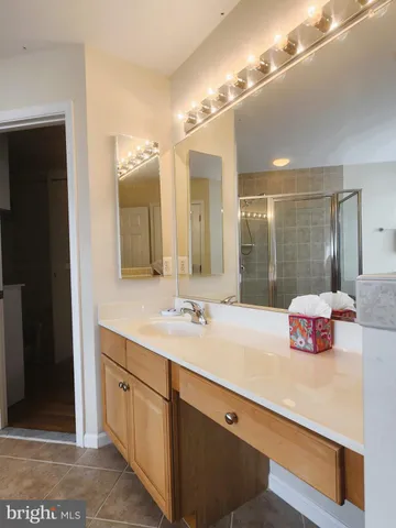 a bathroom with a sink a mirror and a shower