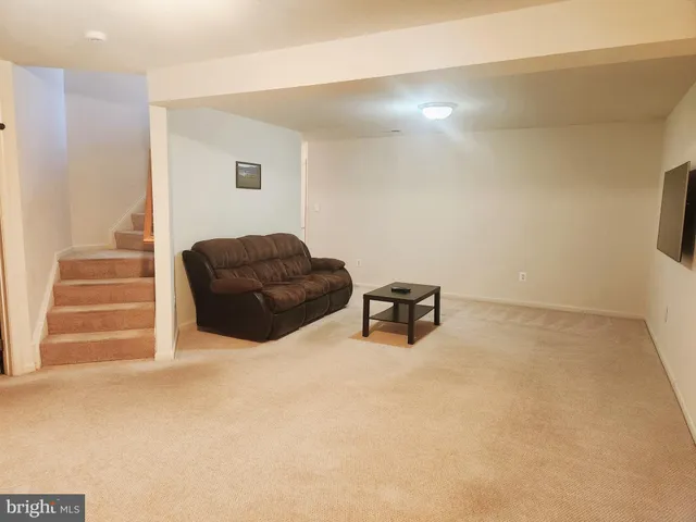a living room with furniture and a lamp